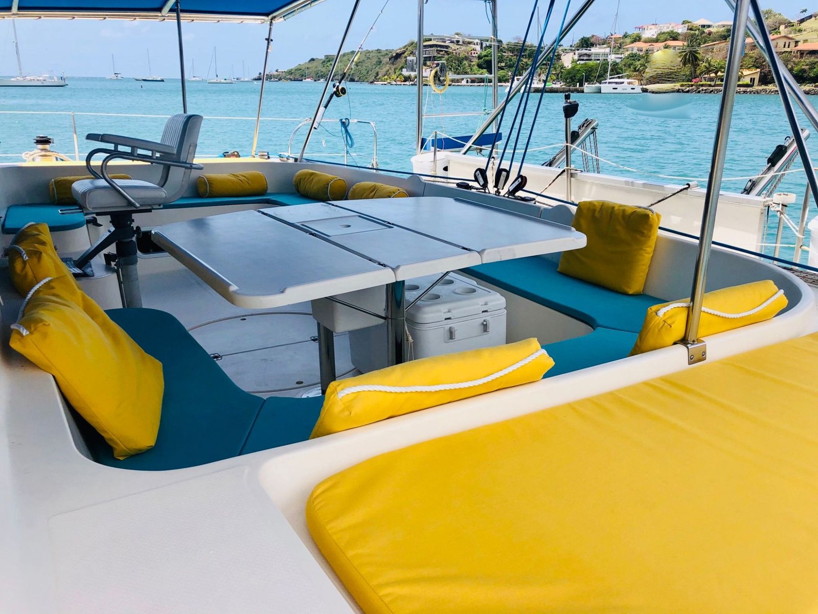 Bacchanal cockpit with teal and yellow cushions and a fishing chair