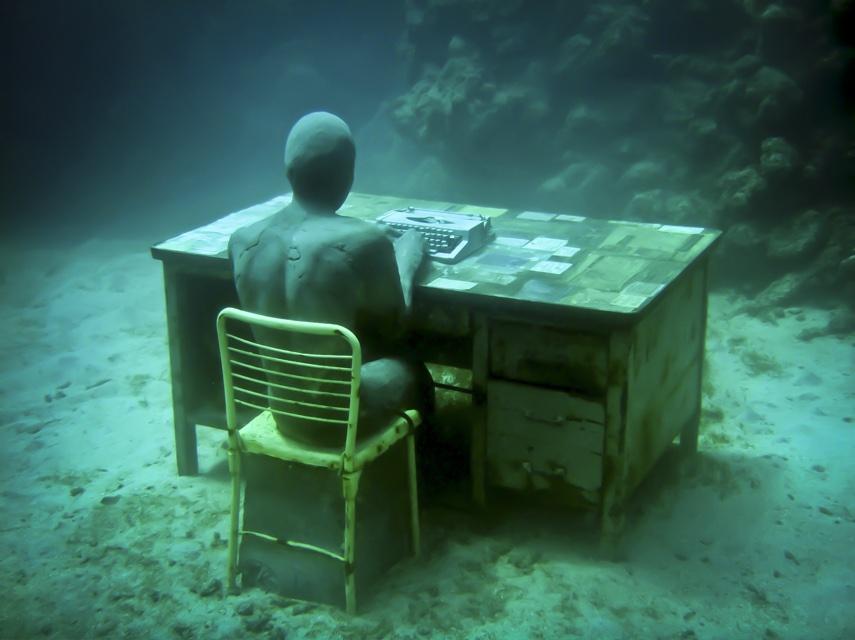 The Lost Correspondent, a sculpted man at a desk with a typewriter on the seabed, Grenada