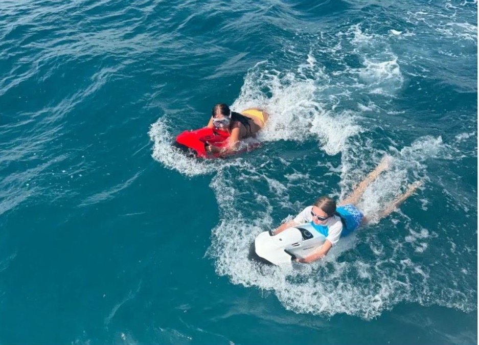 Two guests riding Seabobs through clear water off Grenada