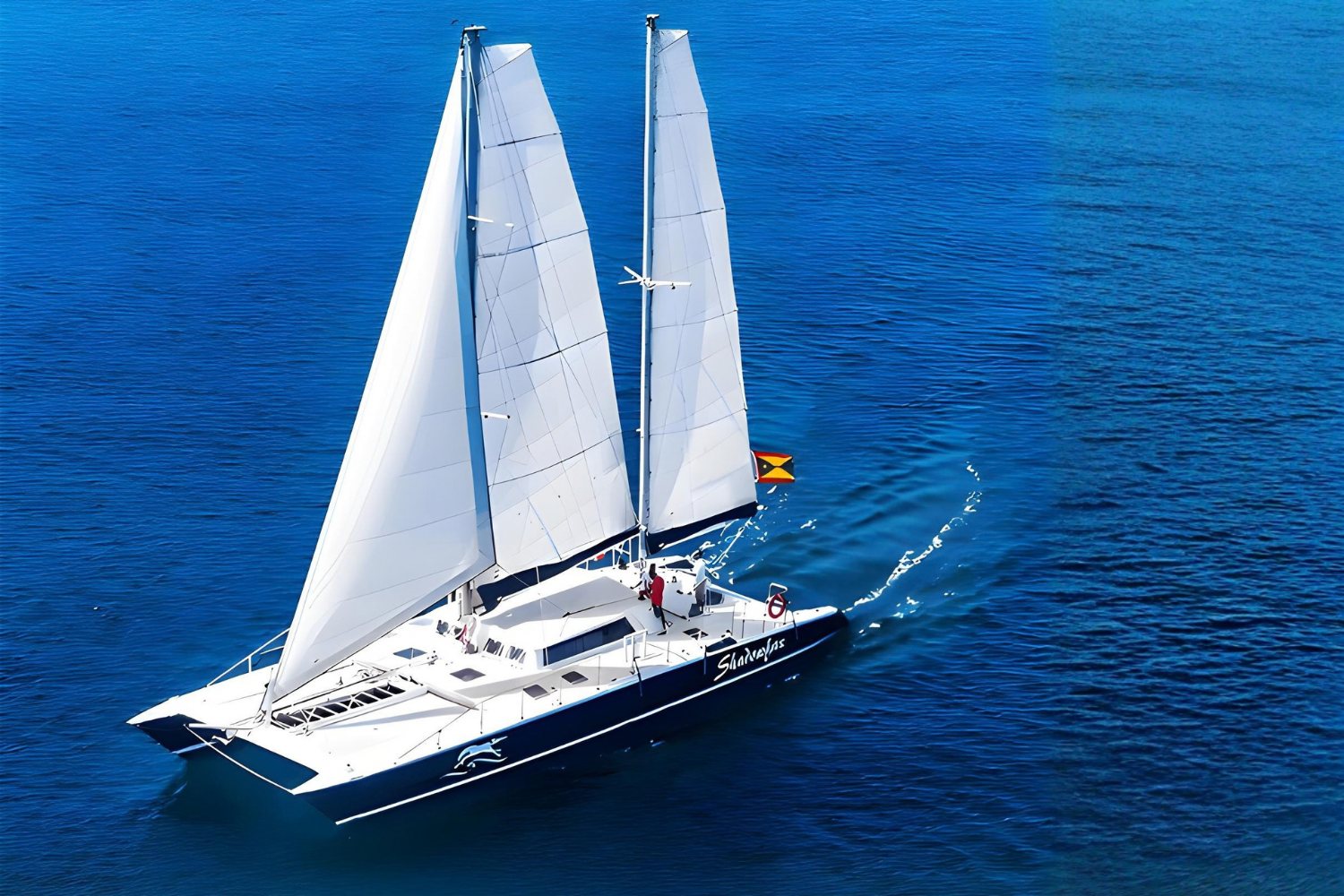 Shadowfax under full sail on deep blue water off Grenada