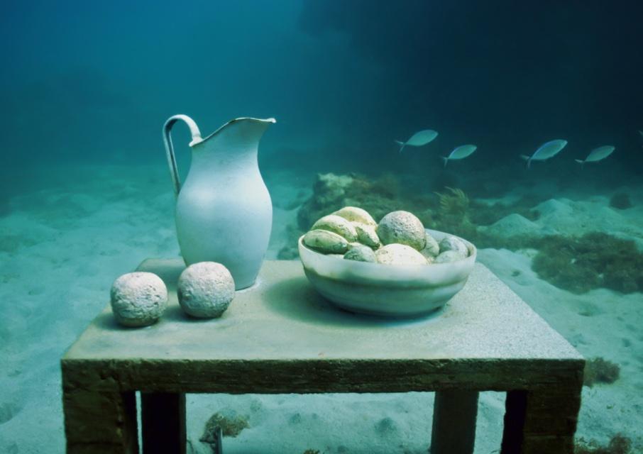 A sculpted table with a jug and a bowl of fruit on the seabed, Molinere Bay, Grenada